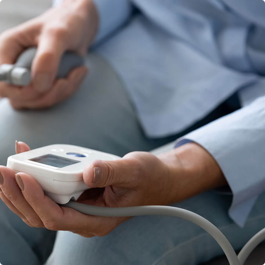 A customer holding a blood pressure monitor