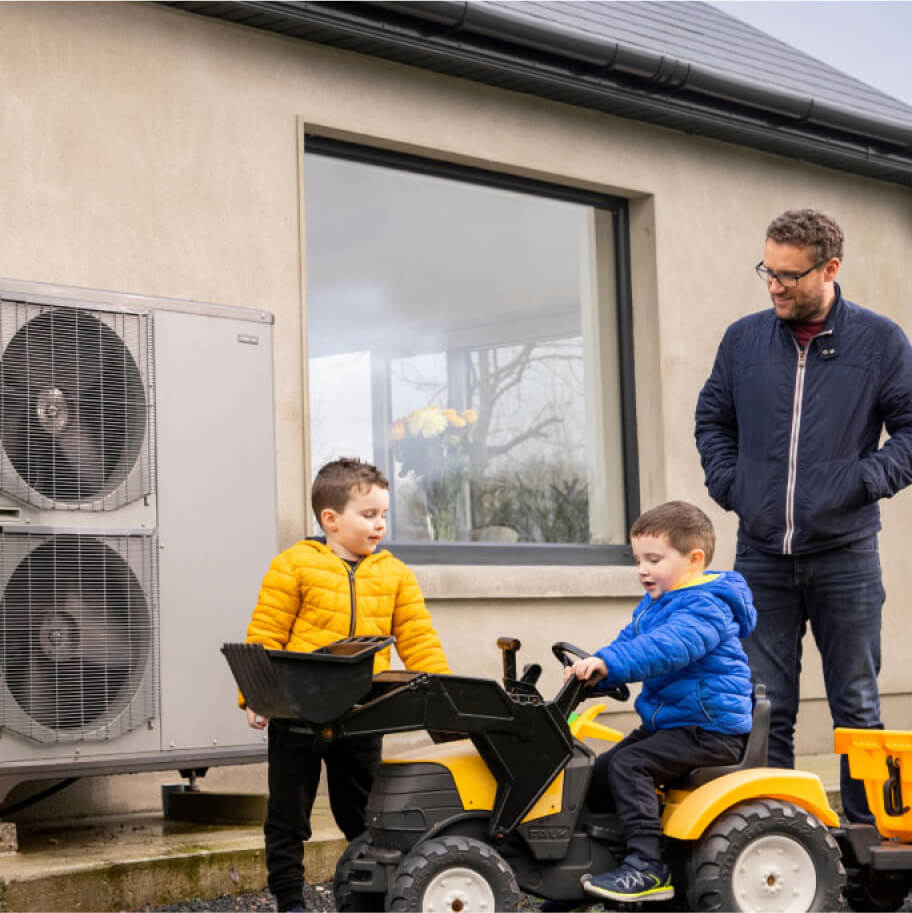 Kids playing on a toy tractor with their dad