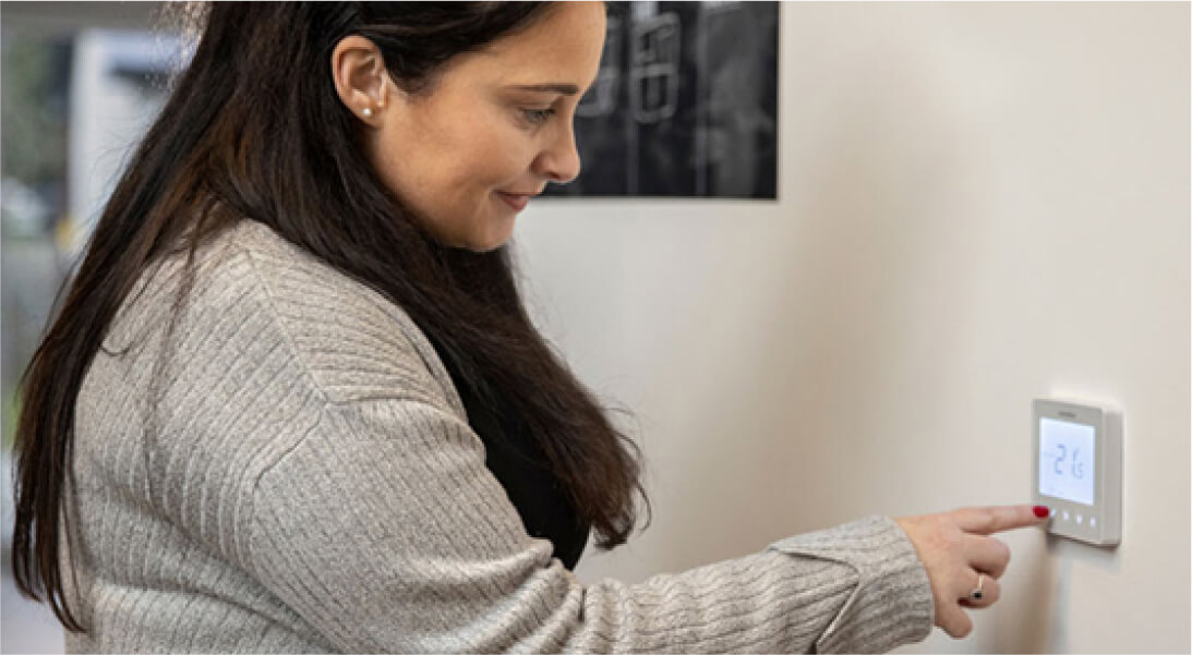 Customer at home using smart thermostat