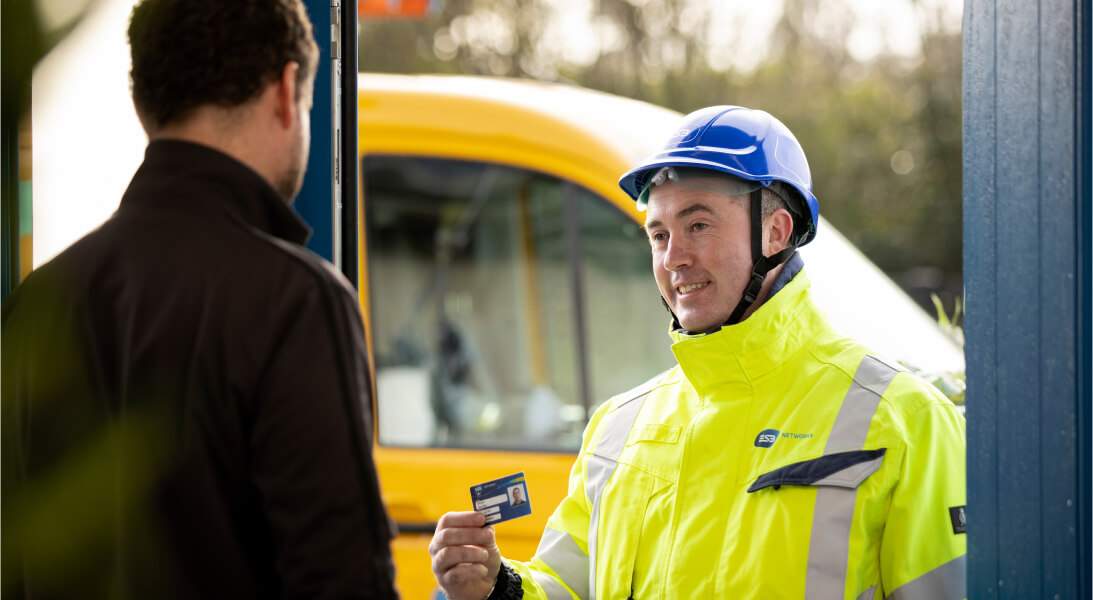 Customer at the door welcoming a technician presenting his company card