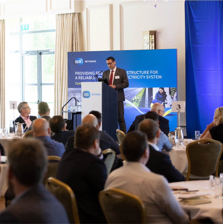 Speaker in front of an audience at a stakeholder event