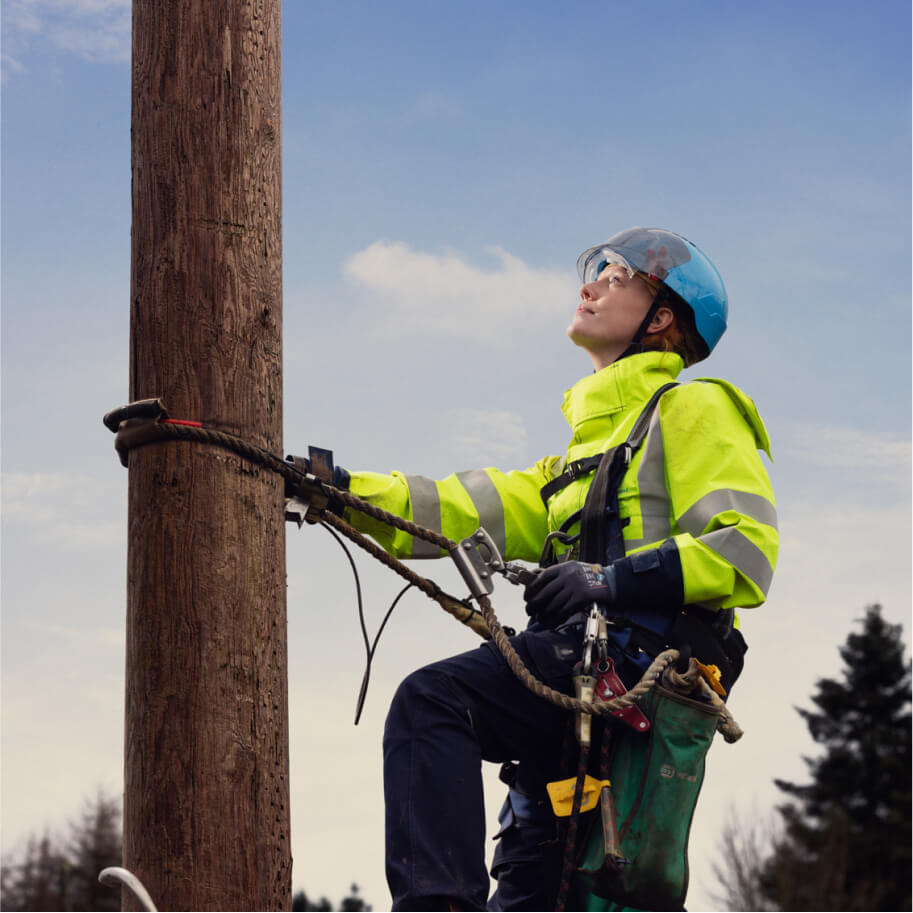 Technician climbing a pole