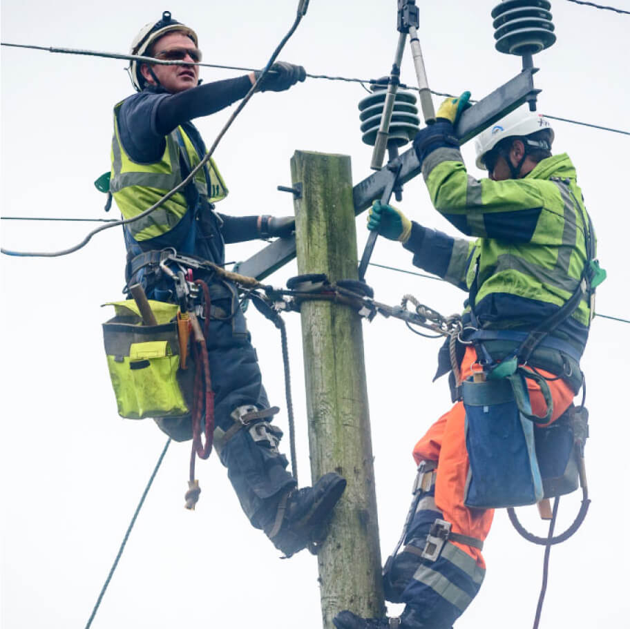 Technicians fixing pole