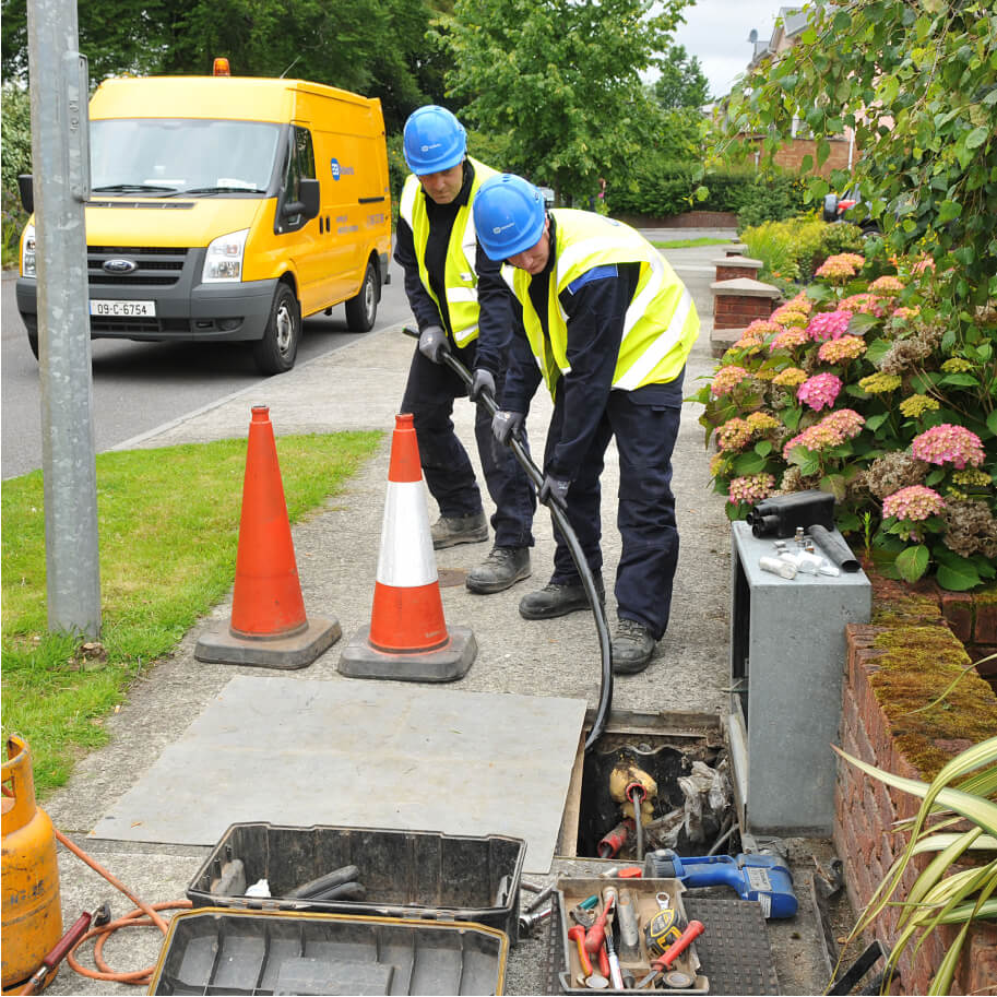 Technicians pulling cables on the street