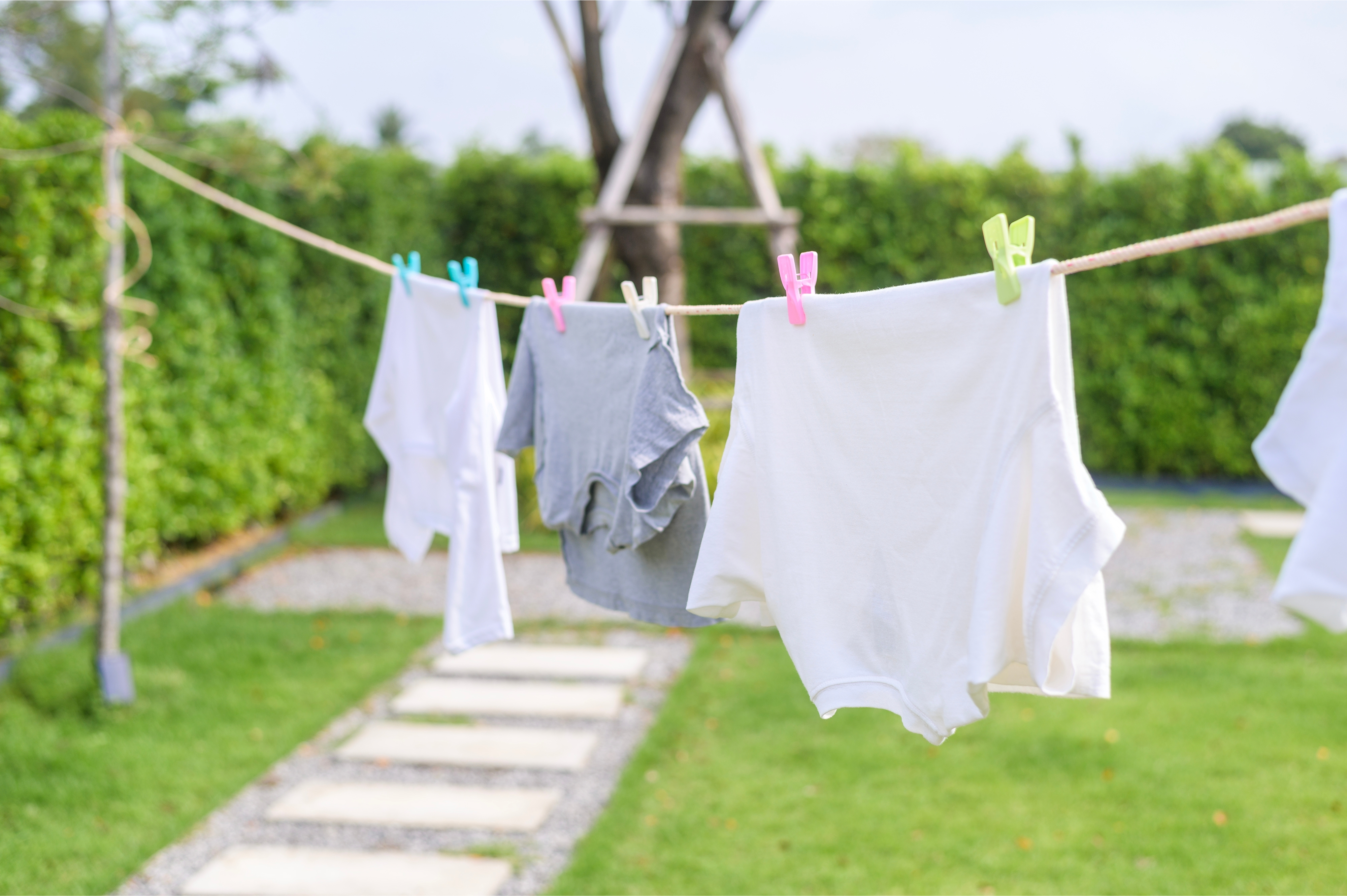 A clothesline with shirts hanging outside.